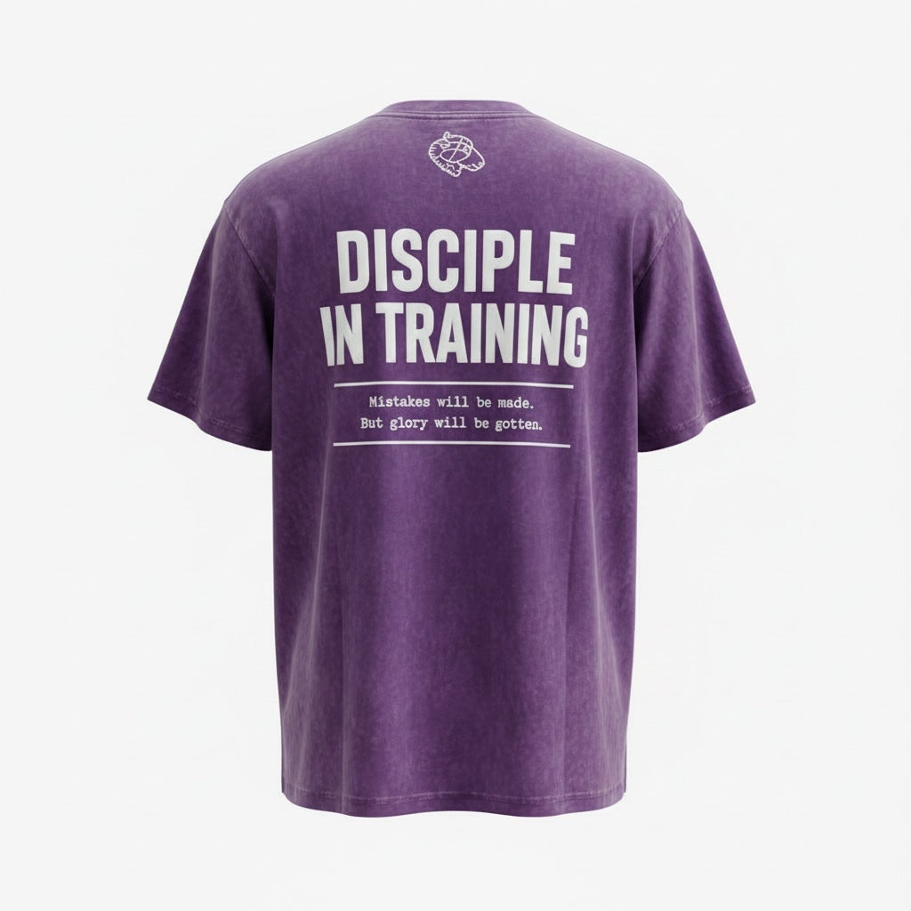 The Promise Brand Co. purple mineral-wash crewneck t-shirt with Disciple in Training graphic on the back.