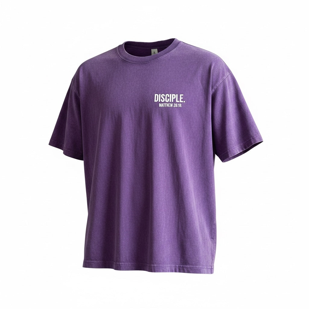 The Promise Brand Co. purple mineral-wash crewneck t-shirt featuring a white Disciple Matthew 28:19 chest graphic.