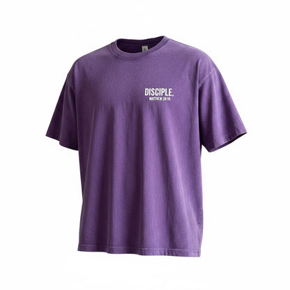 The Promise Brand Co. purple mineral-wash crewneck t-shirt featuring a white Disciple Matthew 28:19 chest graphic.